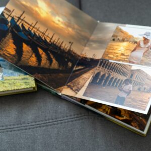 Family photos archive saved in brightly designed photo book; bright summer memories placed in the