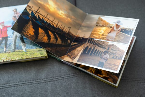 Family photos archive saved in brightly designed photo book; bright summer memories placed in the